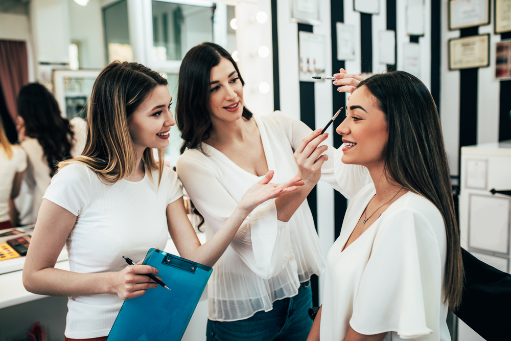 Professional,Makeup,Artist,Teaching,Student,In,Makeup,School. | L Makeup Institute Student learning makeup with teacher and client
