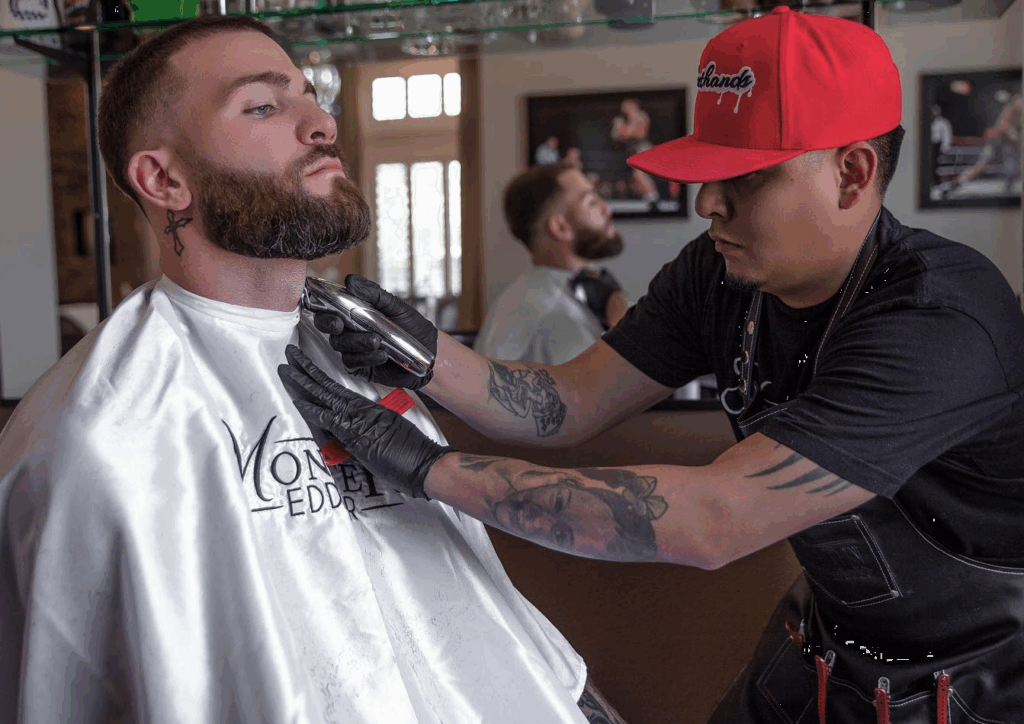 The boxer Caleb Plant getting barbering from Eduardo Gallegos