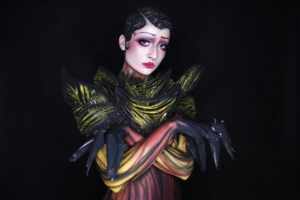 Avant-garde body painting and Hollywood-style makeup design by student at L Makeup Institute, featuring high-fashion painted textures and sculpted costume elements